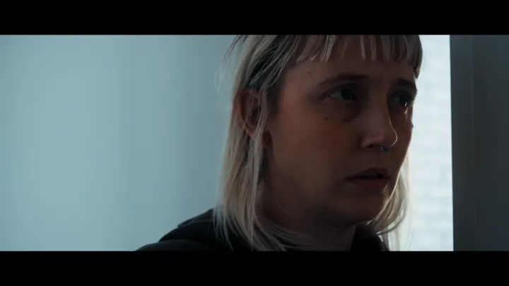 A close portrait of a woman looking away.